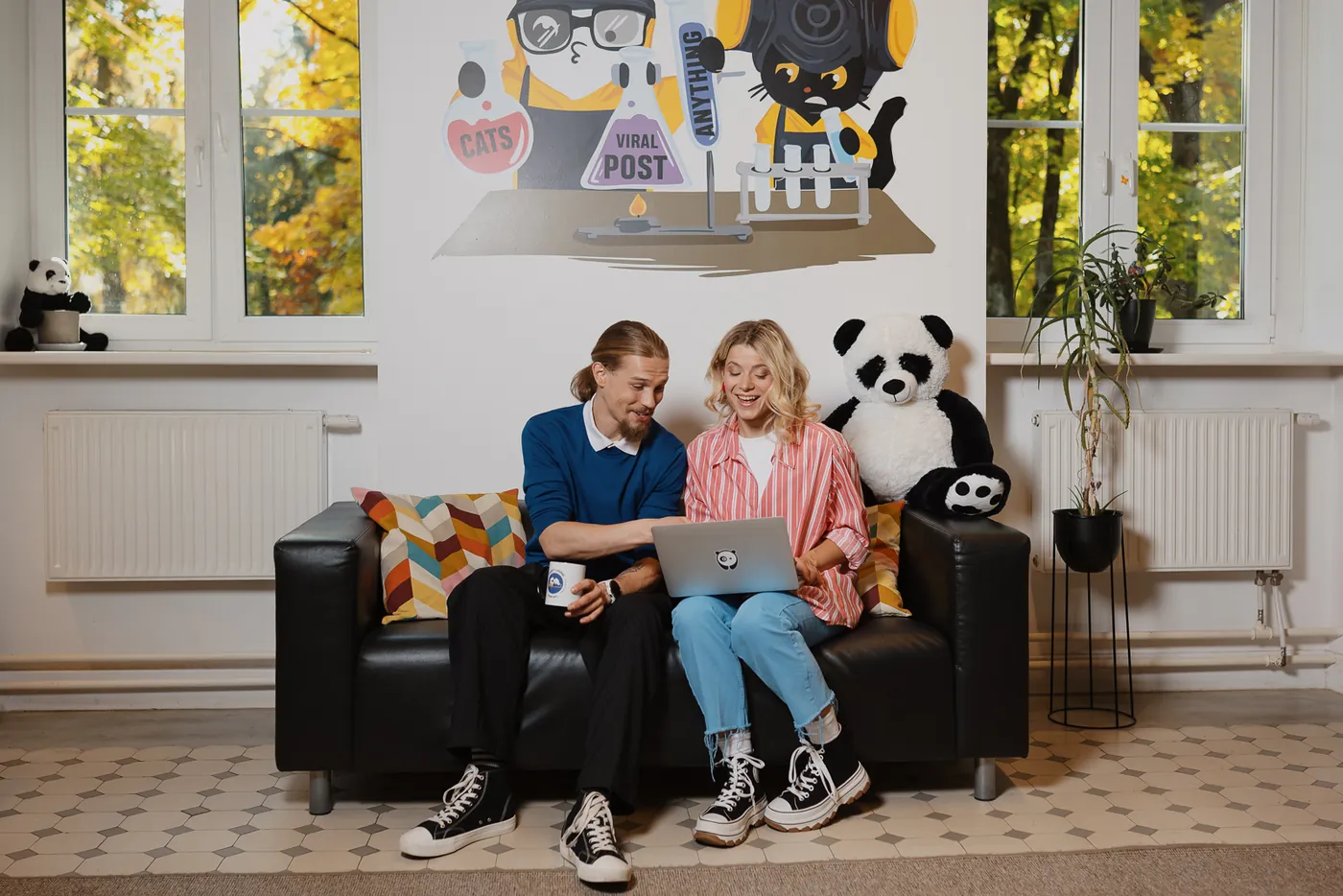 Bored Panda team working together on a laptop in the Vilnius office