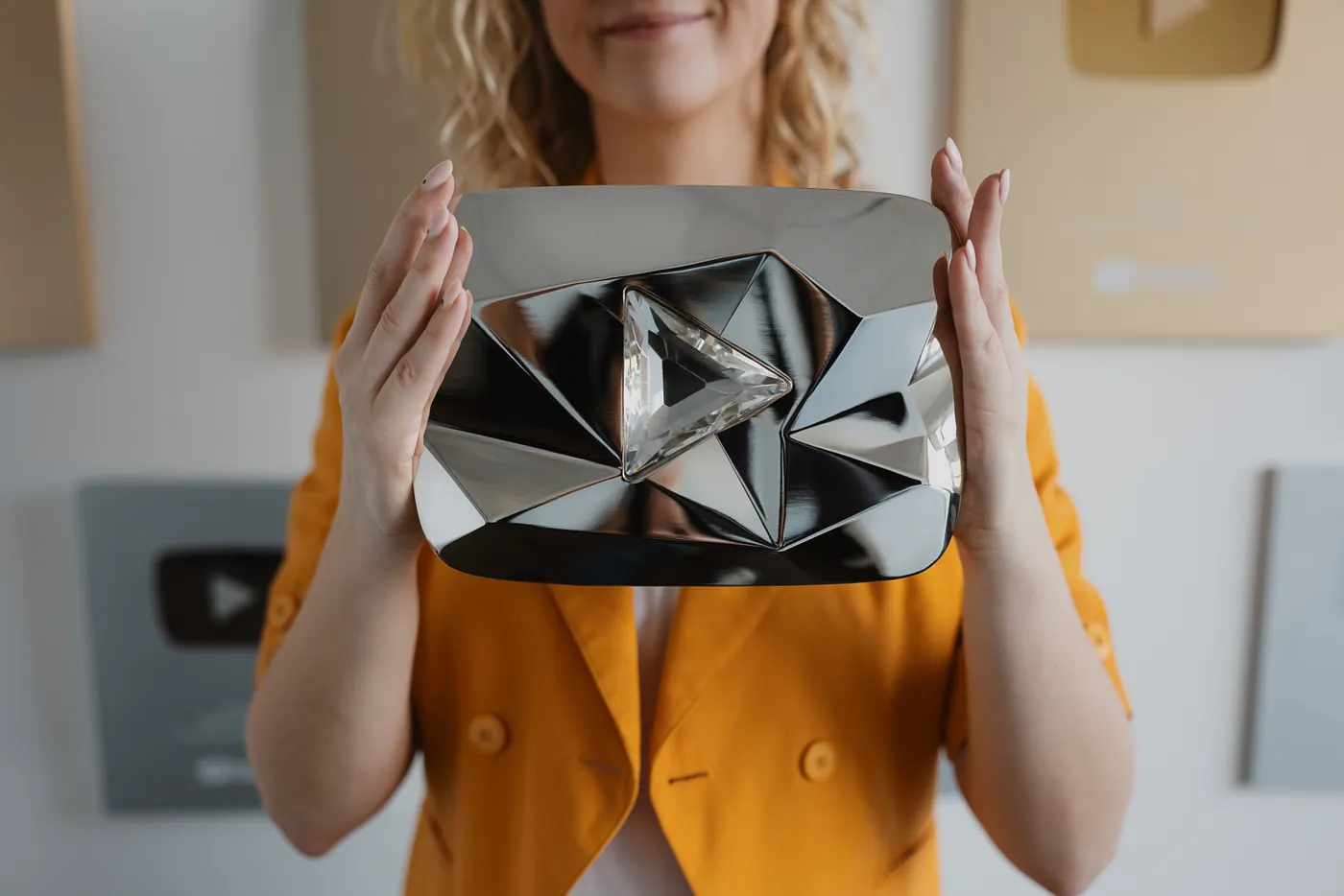 Team member holding the YouTube Diamond Play Button award